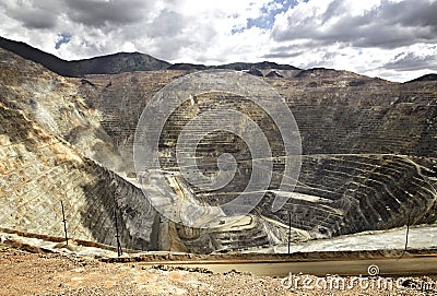 Large quarry site. Big yellow mining truck at work site. Loading sand into body truck. Production useful minerals. Mining truck Stock Photo