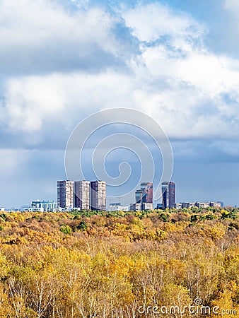 Large rainy clouds over yellow forest and town Stock Photo