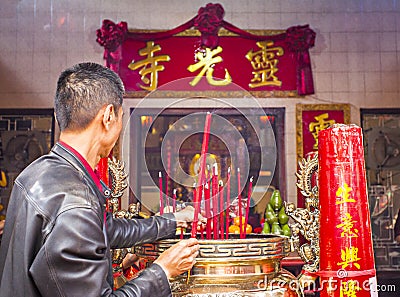 Large red candles are lit at the temples to celebrate Chinese New Year. Editorial Stock Photo