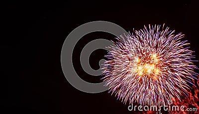 Large red, purple, gold, and white starburst fireworks with a black background Stock Photo