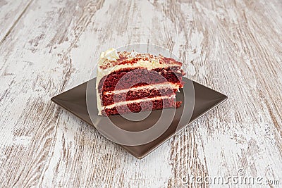 Large red velvet cake with three layers of red sponge cake and three more of white garnish Stock Photo