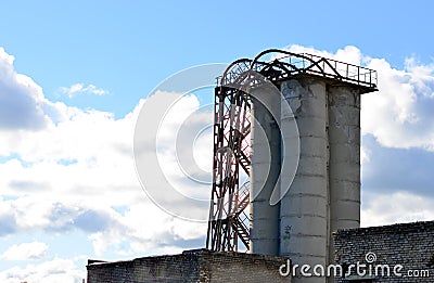 Large reinforced concrete pipe construction with a metal ladder against a bright blue sky Stock Photo