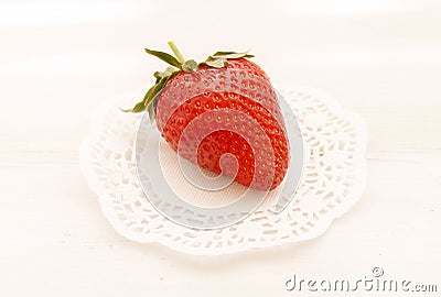 The large ripe strawberry on a plate Stock Photo