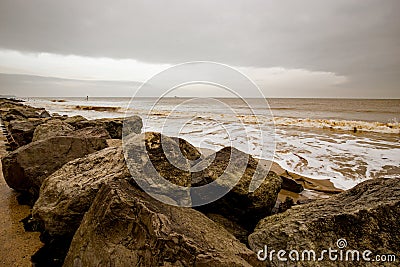 Large rocks and boulders on the Norfolk Coast protecting the coastline Stock Photo