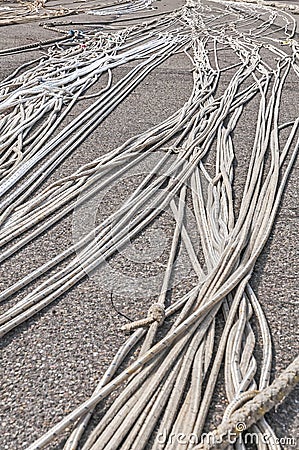 Large ropes spread out on the harbour quay Stock Photo