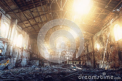 Large ruined and demolished abandoned factory hangar or warehouse in sunlight, post apocalyptic disaster concept Stock Photo