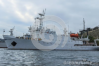 A large Russian ship of the Black Sea Fleet in the port of Sevastopol against the background of the gray sky. Russian Editorial Stock Photo