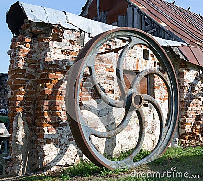 Large rusted metal industrial wheel against the background of an Stock Photo