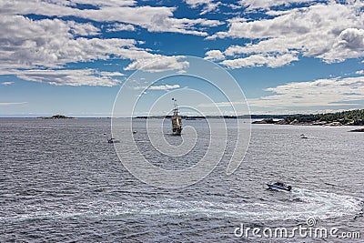 A large sailing frigate, barque or brig sails on a calm sea Stock Photo