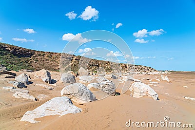 Large sandy beach with stone boulders. Summer landscape Stock Photo