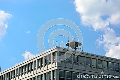 Large Satellite Dish on Top of An Office Building Roof Stock Photo