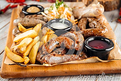 Large sausage platter sauerkraut potatoes sauce Stock Photo