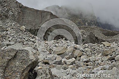 Large section from Khumbu glacier with layers made by ice, rocks, mud, small vegetation. Nepal. Stock Photo