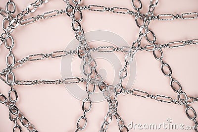 Large shiny metalic silver chains on pastel surface top view Stock Photo