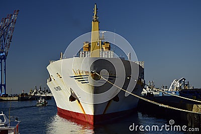 A large ship and fishing boats at the pier in the port of Valparaiso. Chili Editorial Stock Photo