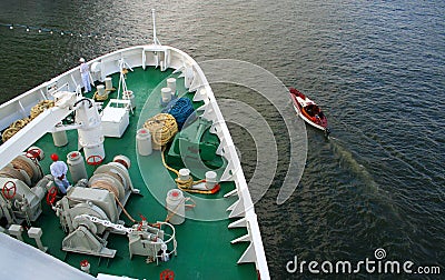 The large ship and small boat beside in the high sea. Stock Photo