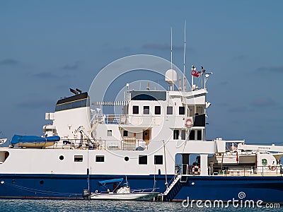 Large ship and tender boat Stock Photo