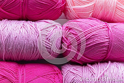 Large size pink and purple balls of elongated woolen acrylic or nylon yarn, taken in full frame close-up on the theme of hobby, Stock Photo