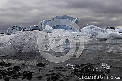 Large And Small Chunks Of Glacier Ice Drift Away In Lagoon Stock Photo