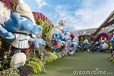 Large Smurfs dolls in clothes of national football teams from World Cup in botanical Dubai Miracle Garden in Dubai city, United Editorial Stock Photo