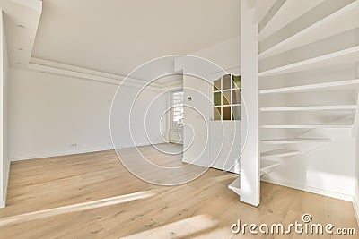 A large spacious room with a staircase Stock Photo