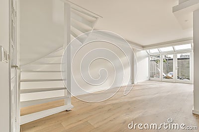 A large spacious room with a staircase Stock Photo