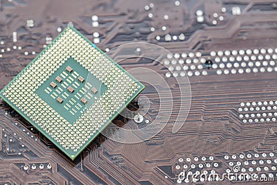 A large square microprocessor for computers lies on motherboard Stock Photo