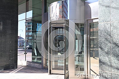 A large stainless steal and glass revolving door in front of an office building in downtown Atlanta Editorial Stock Photo