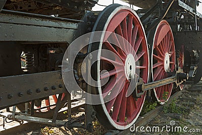 Large steel wheels of old steam locomotive red with white outline Stock Photo