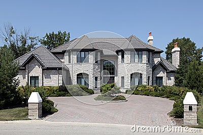 Large stone home with pillars Stock Photo