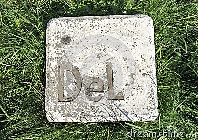 Large stone installation button delete makes an imitation computer key lying on the green grass Stock Photo