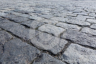 Large stones of a cobblestone paved bridge. Close-up Stock Photo