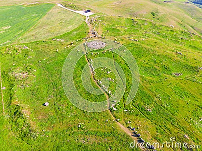 Large stones in a field with round holes in Karahunj - Armenian Stonehenge, Zorats Karer Stock Photo