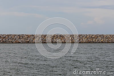 Large stones Was prepared in place of the sandy beach for the wave walls Stock Photo