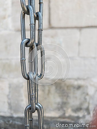 Large strong metallic chain in vertical position Stock Photo