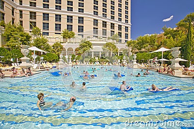 Large swimming pool with swimmers at Bellagio Casino in Las Vegas, NV Editorial Stock Photo