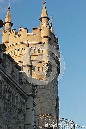 A large tall tower with a clock on the side of a building Stock Photo