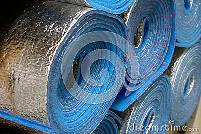 Large thermo alluminium foiled polyethylene rolls for sheating houses and buildings to make it warm in storage Stock Photo