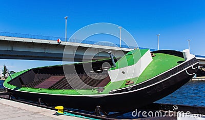 Tilted empty boat on docking ramp, Odra River, Poland Stock Photo