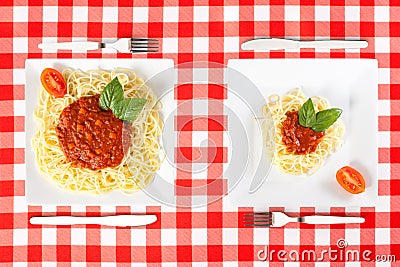 Large and tiny food portions Stock Photo