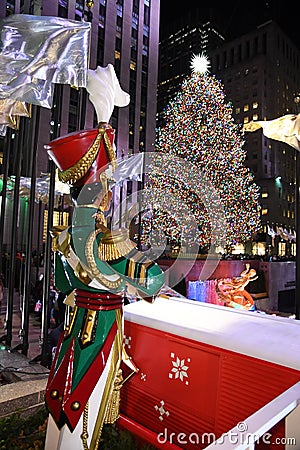 A Large toy nutcracker drummer statue and the holiday lights in Rockefeller Center Editorial Stock Photo