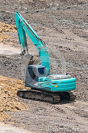 A large trackhoe moving rock Stock Photo