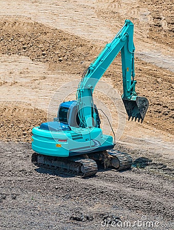 A large trackhoe moving rock Stock Photo