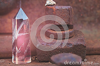 Large transparent mystical faceted crystal of colored pink amethyst, chalcedony on a rails on industrial background close-up Stock Photo