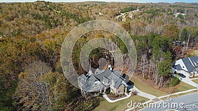 Large two-story suburban houses on huge lot size lush green tree, well-trimmed landscape, long concrete drive way in Flowery Stock Photo