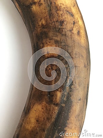 Large unpeeled banana lying close up on a white background. Abstract minimalistic texture background. Stock Photo