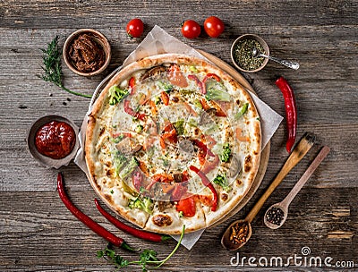 Large vegeterian pizza with sauces and pepper Stock Photo