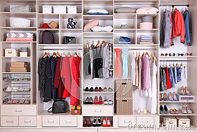 Large wardrobe with different clothes, home stuff and shoes Stock Photo