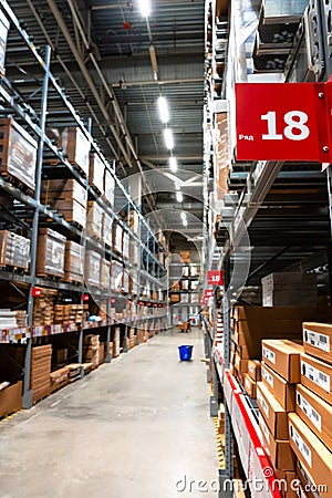 Large warehouse interior with rows of shelves and carts in IKEA Editorial Stock Photo