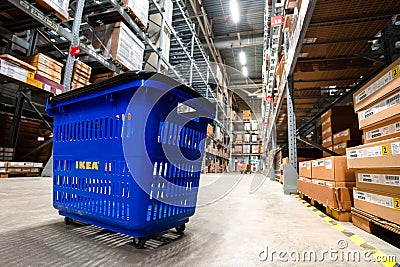 Large warehouse interior with rows of shelves and carts in IKEA Editorial Stock Photo